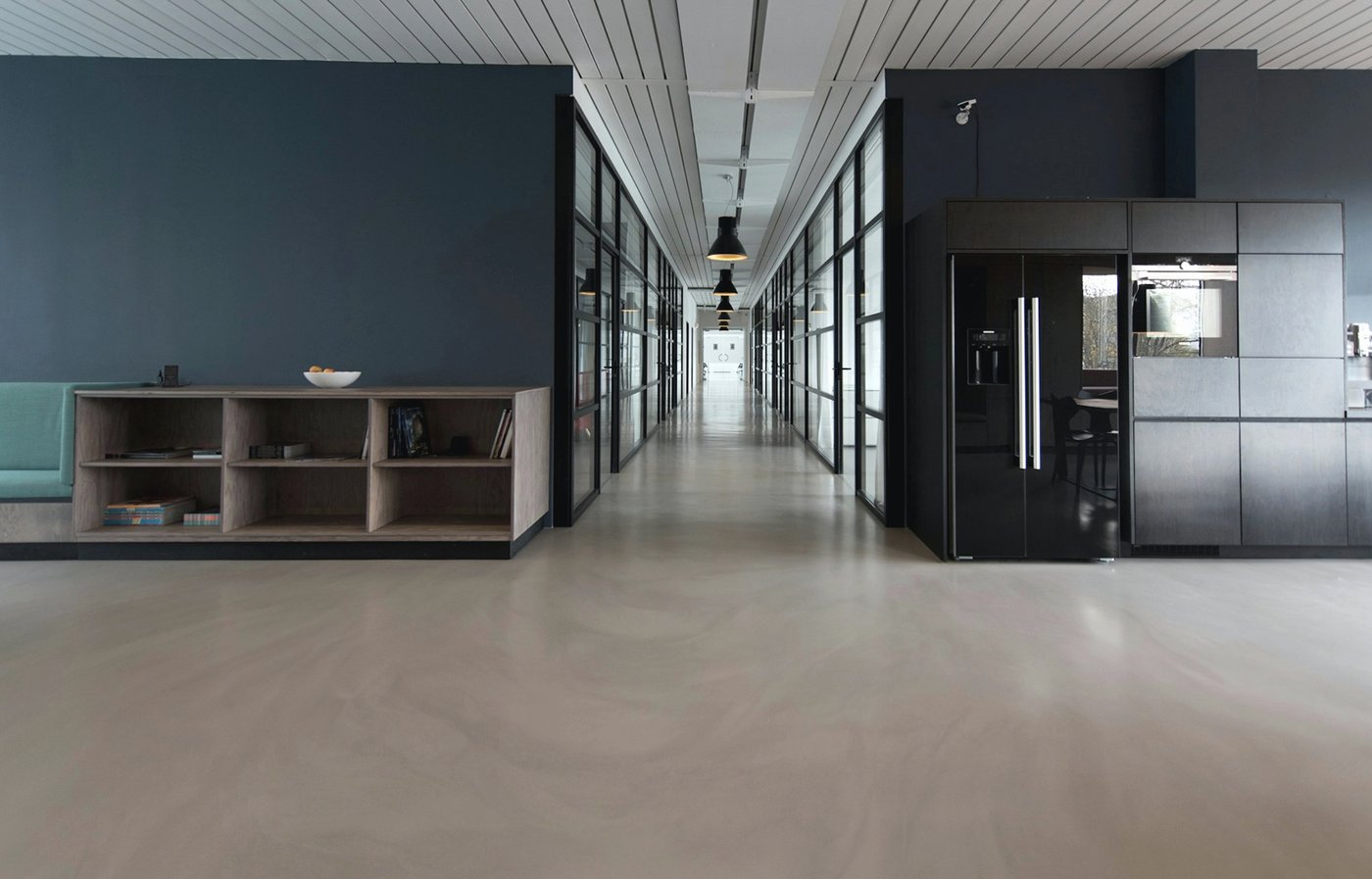 Polished office corridor with glass partitions and a staff kitchen